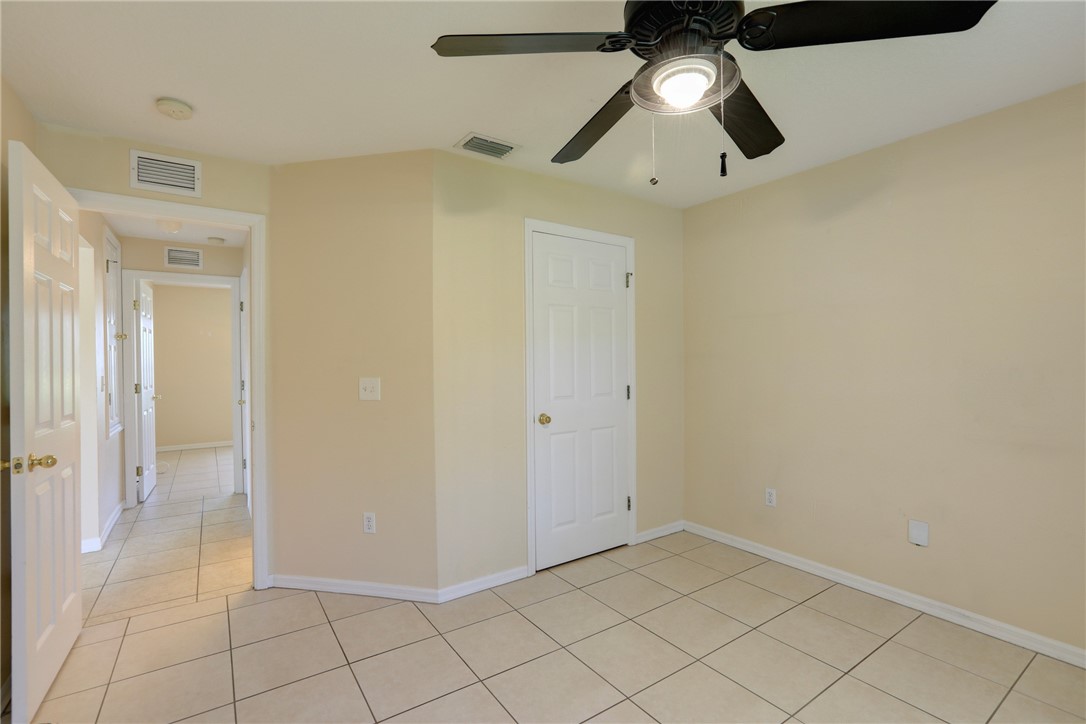 113 Drake Way Sebastian, FL 32958 - Photo 29 of 36 an empty room with a ceiling fan and carpet