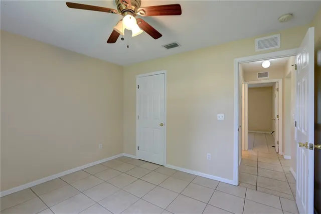 an empty room and chandelier fan