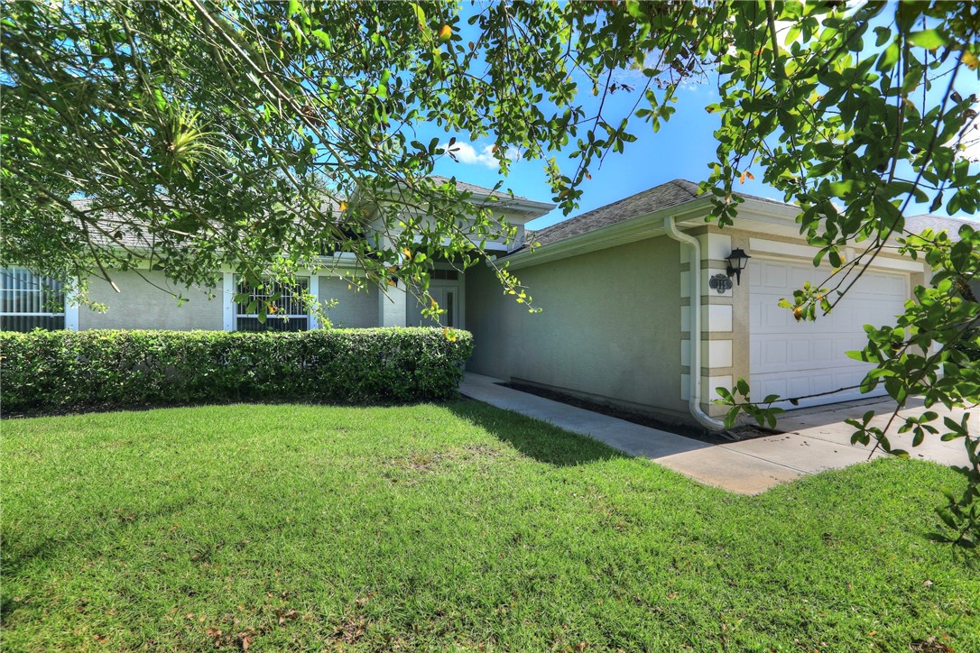 113 Drake Way Sebastian, FL 32958 - Photo 3 of 36 a view of backyard with a garden and trees