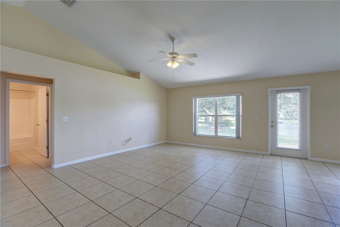 113 Drake Way Sebastian, FL 32958 - Photo 10 of 36 an empty room with windows and fan