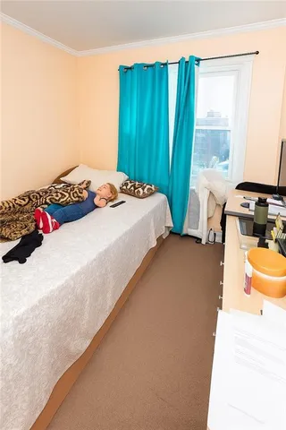 a bedroom with 2 bed and a window