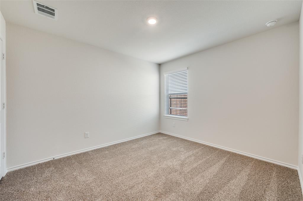 775 Tiger Lily Way Pilot Point, TX 76258 - Photo 10 of 13 an empty room with a empty space and window