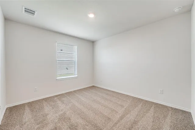 an empty room with a empty space and window