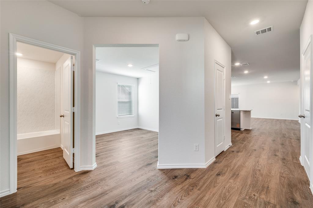 775 Tiger Lily Way Pilot Point, TX 76258 - Photo 3 of 13 a view of a hallway with wooden floor