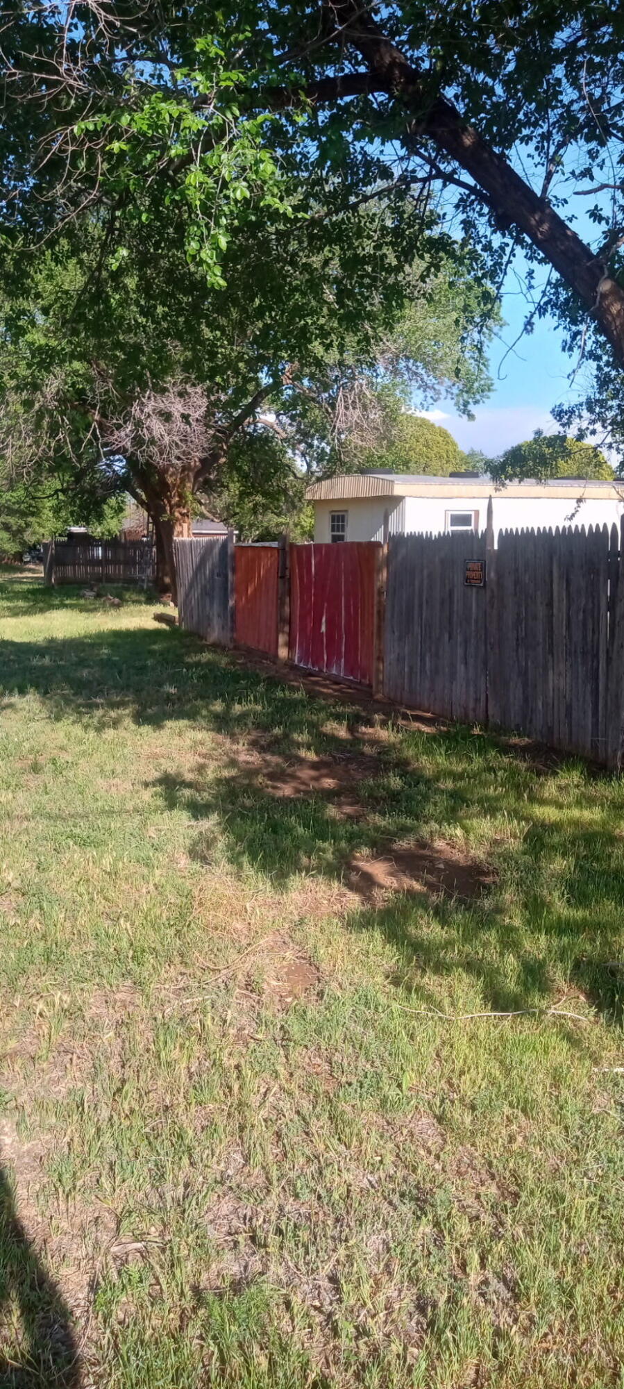 815 South 3rd Street Slaton, TX 79364 - Photo 7 of 9 a view of a yard with wooden fence