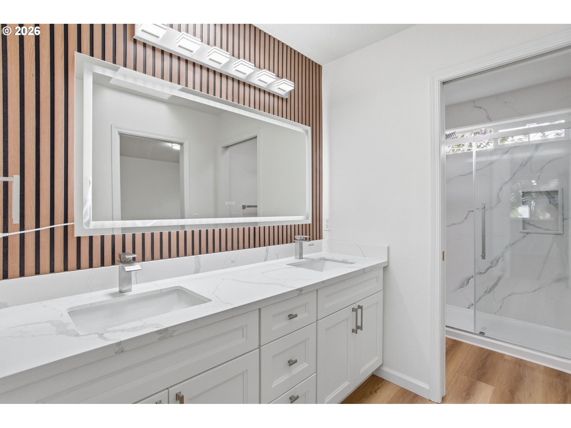 8911 Southwest Gravenstein Lane Tigard, OR 97224 - Photo 26 of 33 a en suite bathroom with a sink a mirror a vanity and the shower