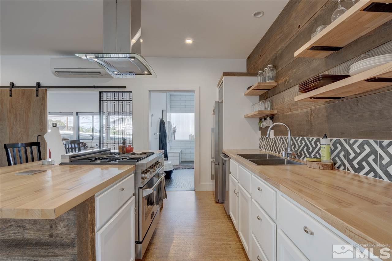 525 Roberts Street Reno, NV 89502 - Photo 29 of 40 a kitchen with stainless steel appliances granite countertop a sink a stove and a refrigerator