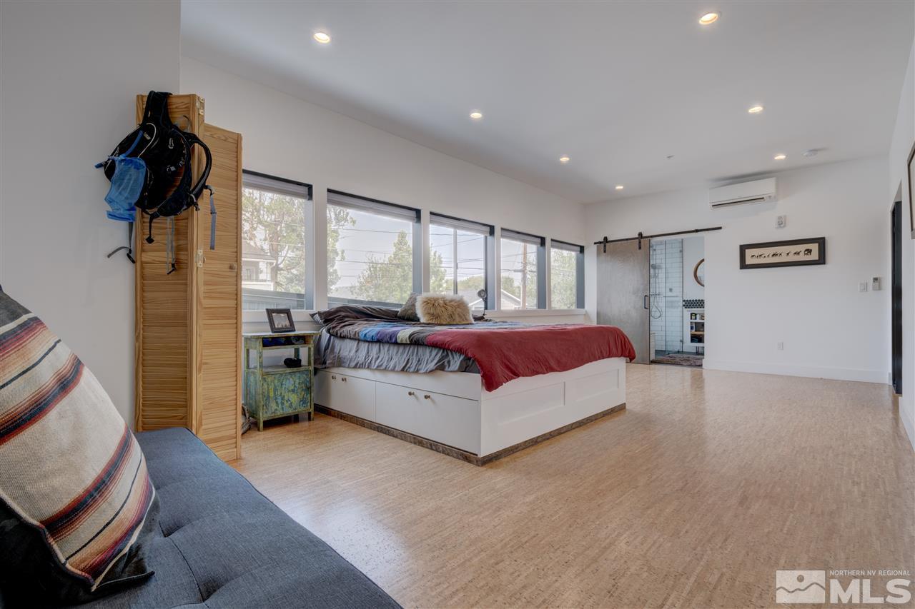525 Roberts Street Reno, NV 89502 - Photo 32 of 40 a spacious bedroom with a bed and a couch