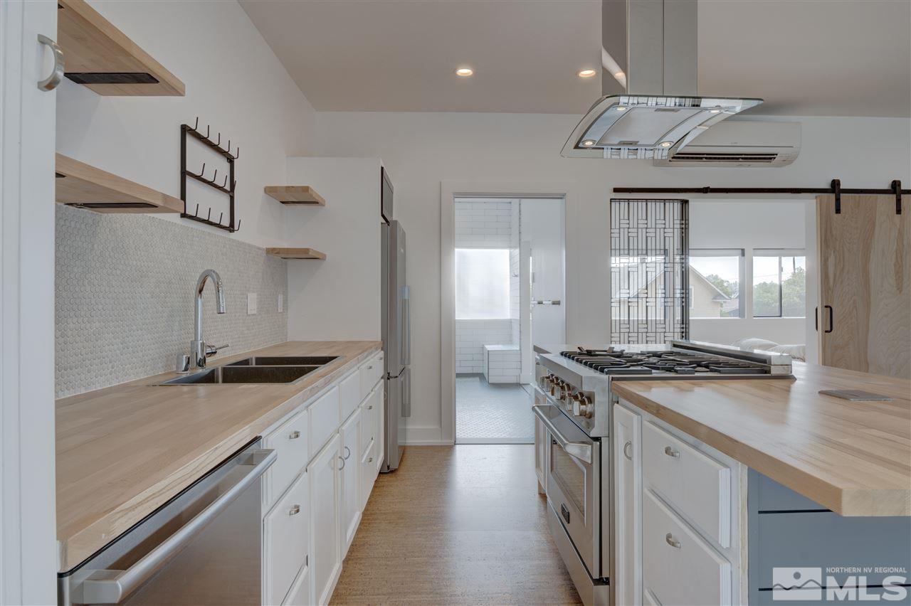 525 Roberts Street Reno, NV 89502 - Photo 8 of 40 a kitchen with stainless steel appliances granite countertop a sink stove and cabinets
