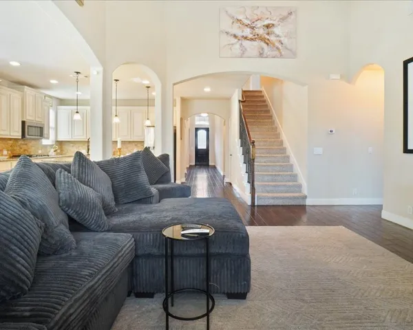 a living room with furniture and wooden floor