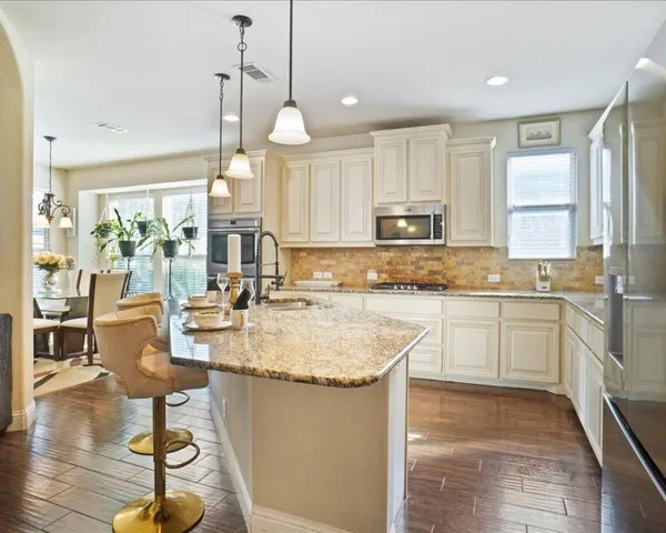 a kitchen with sink stove and cabinets