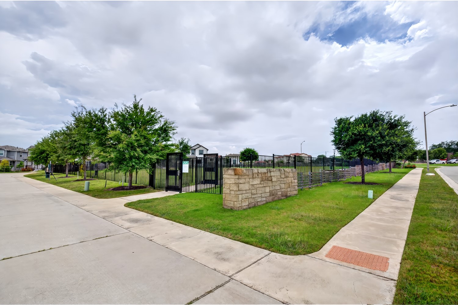 2006 Grow Lane Austin, TX 78754 - Photo 37 of 40 A well-maintained community park space with established trees and secure fencing.