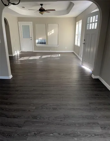 a view of water heater room with wooden floor