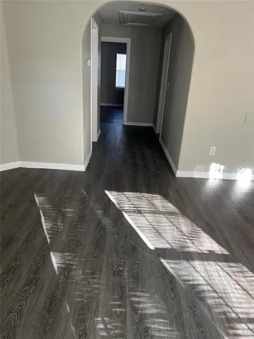 a view of a hallway view with wooden floor and staircase