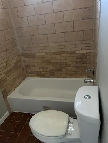 an empty room with wooden floor and a window