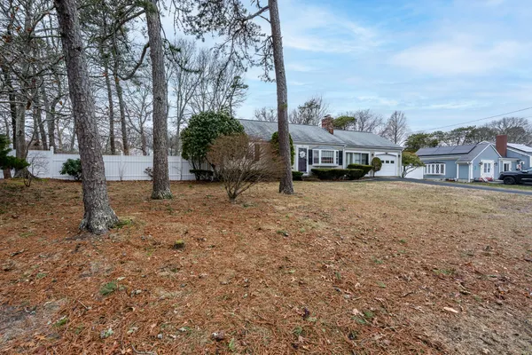 a view of a house with a yard and sitting area