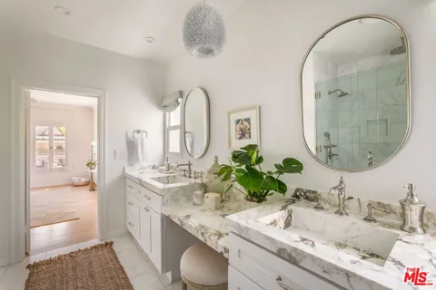 a bathroom with a granite countertop sink mirror and vanity