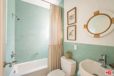 a bathroom with a toilet a sink and a bathtub