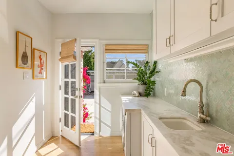 a kitchen with a refrigerator and sink