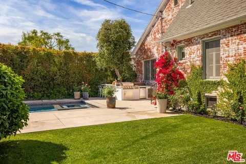 a view of a house with a yard and sitting area