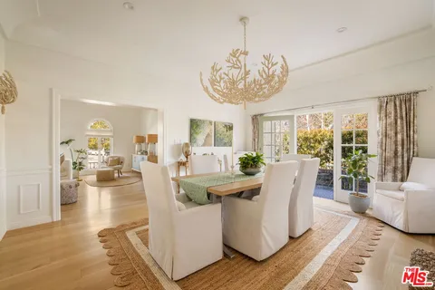 a view of a dining room with furniture wooden floor and chandelier