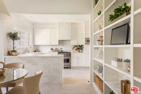 a kitchen with cabinets a sink and appliances
