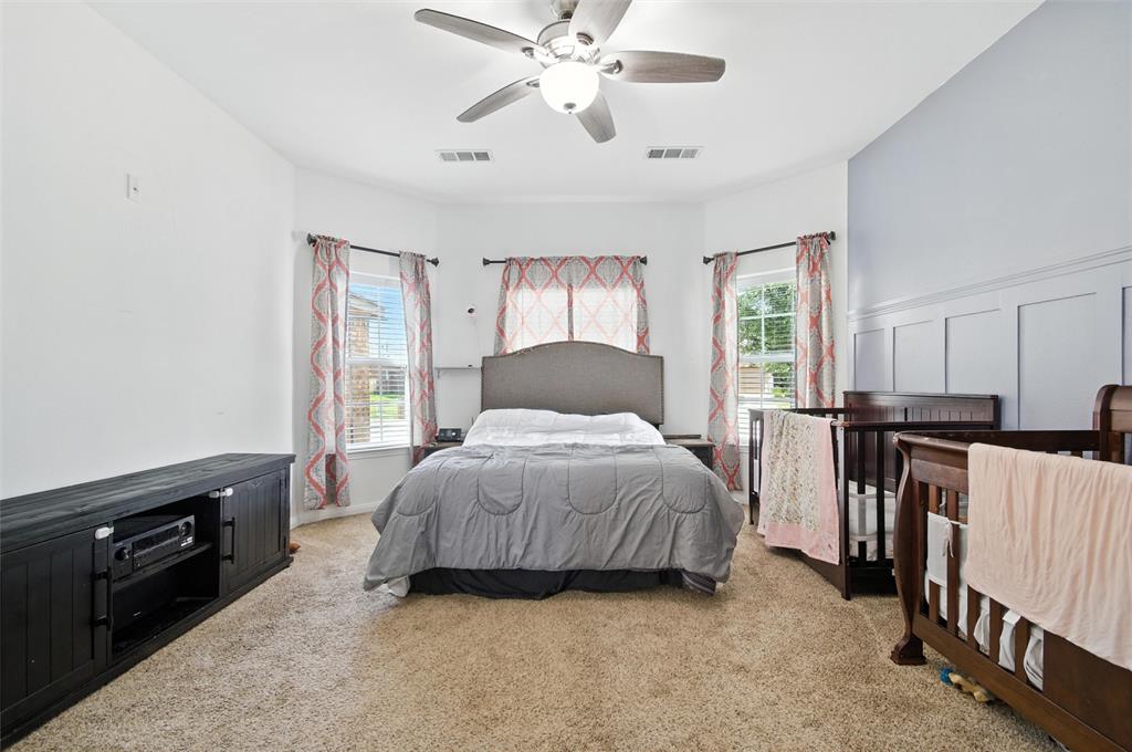 1100 Port Way Crowley, TX 76036 - Photo 24 of 31 a bedroom with a bed and a chandelier