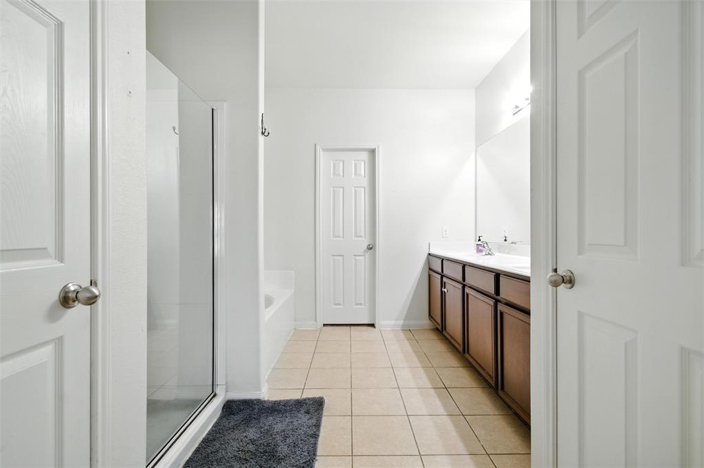 1100 Port Way Crowley, TX 76036 - Photo 26 of 31 a bathroom with a sink a mirror and a shower