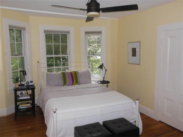 70 Ward Street Lexington, MA 02421 - Photo 11 of 12 a bedroom with a bed and wooden floor