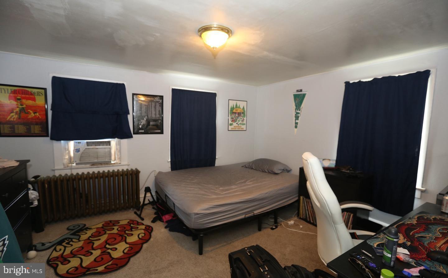 114 Ellis Street Glassboro, NJ 08028 - Photo 6 of 11 a bedroom with furniture and a flat screen tv