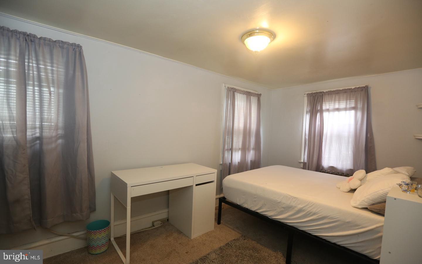 114 Ellis Street Glassboro, NJ 08028 - Photo 7 of 11 a bedroom with a bed and a table