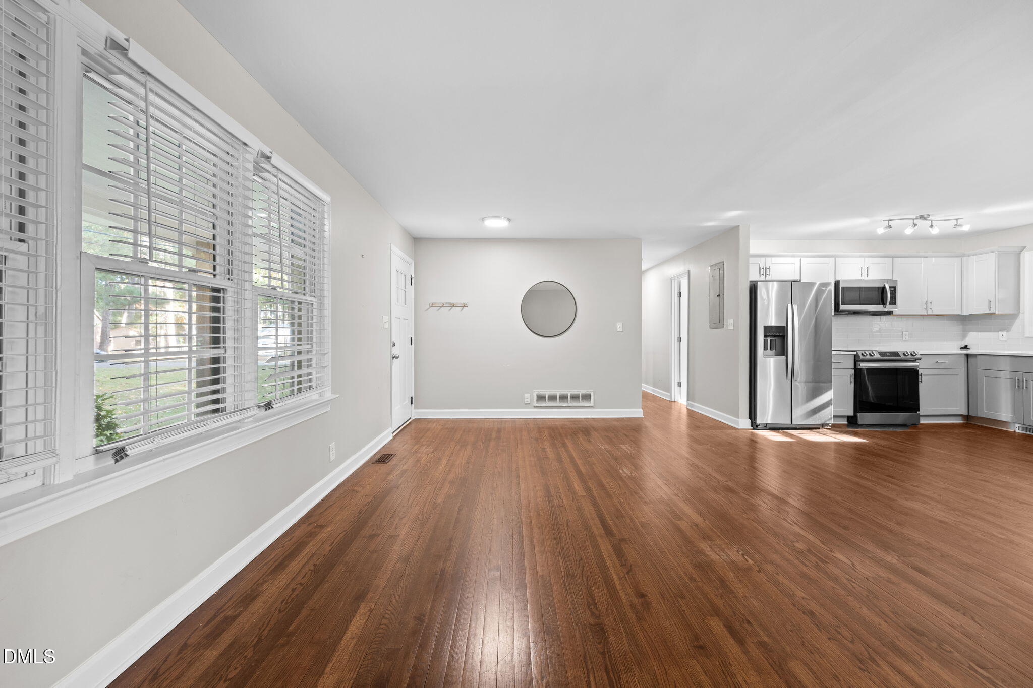 2950 Glenridge Drive Raleigh, NC 27604 - Photo 12 of 53 a view of empty room with wooden floor and fireplace