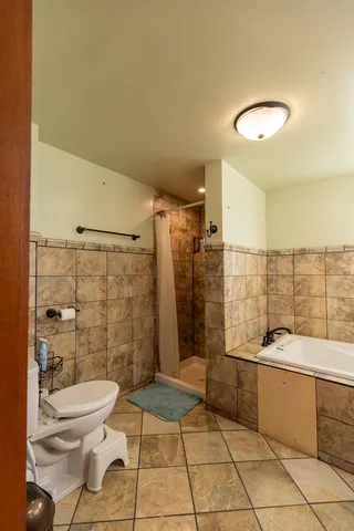 a bathroom with a sink mirror toilet and shower