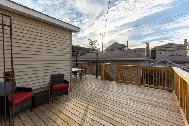 a view of roof deck with wooden floor and seating space