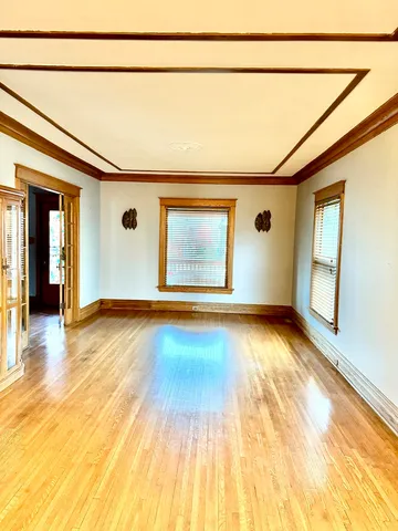 a view of a room with wooden floor and window