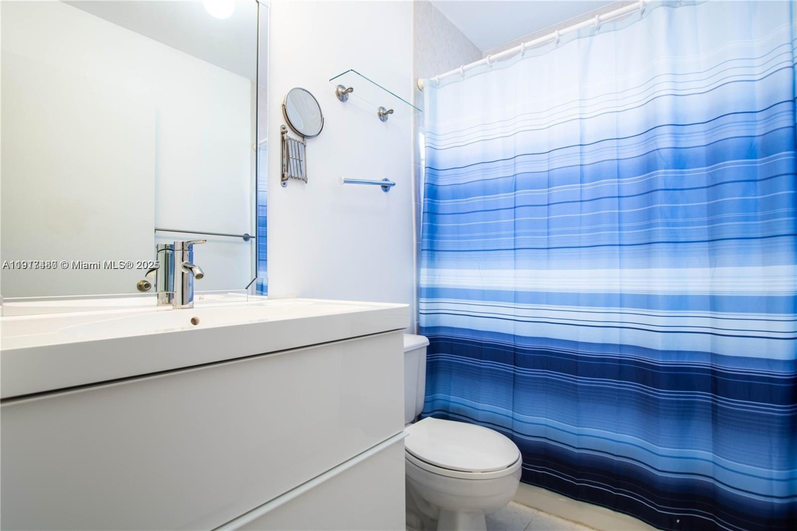 16227 Southwest 139th Court, Unit 2 Miami, FL 33177 - Photo 9 of 10 a bathroom with a sink a toilet and shower