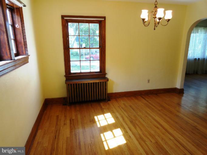 411 Forest View Road Linthicum Heights, MD 21090 - Photo 3 of 30 a view of empty room with wooden floor and fan