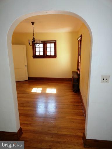 411 Forest View Road Linthicum Heights, MD 21090 - Photo 8 of 30 a view of a room with wooden floor and a window