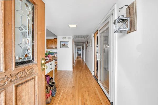a living room with furniture a flat screen tv and a large window