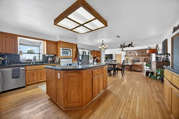 a view of a dining room and livingroom with furniture wooden floor