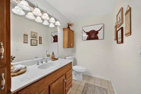 a large bathroom with a large tub and sink