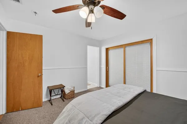 a view of a house with a big yard and large trees