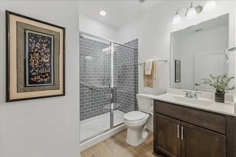 a bathroom with a double vanity sink mirror and shower