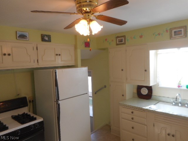 15712 Turney Road Maple Heights, OH 44137 - Photo 4 of 19 BRIGHT & CHEERY KITCHEN WITH A LIGHTED CEILING FAN, AND COMES COMPLETE WITH THE FRIDGE & GAS STOVE.