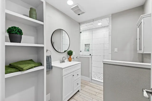 a bathroom with a double vanity sink and a mirror