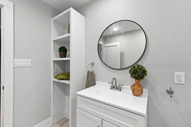 a bathroom with a sink and mirror
