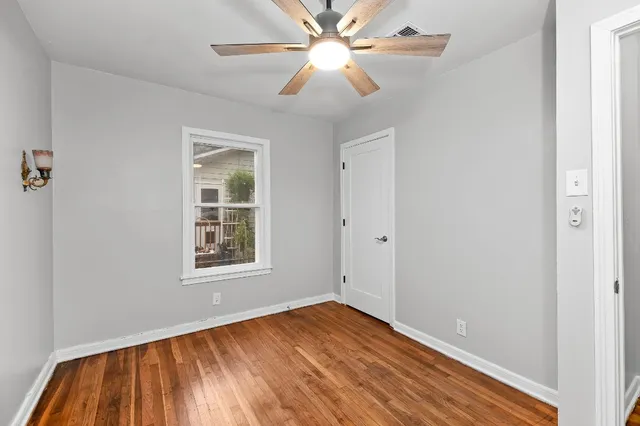 wooden floor in an empty room with a window