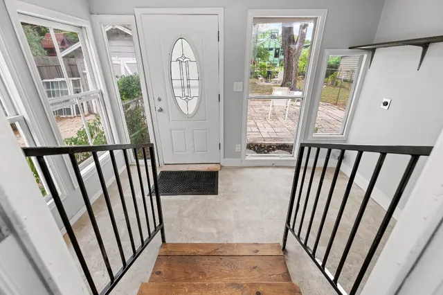 a view of a porch with wooden floor and windows