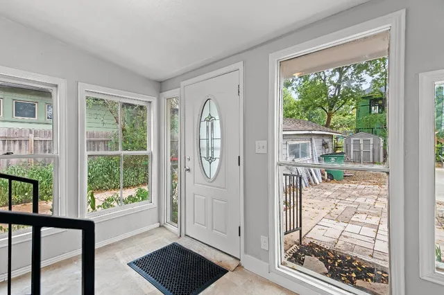 a view of a porch with wooden floor and front door