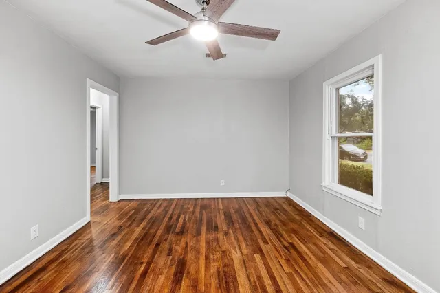 wooden floor in an empty room with a window